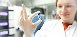 scientist holds sample tube