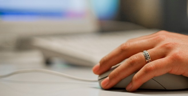 Hand holding a computer mouse