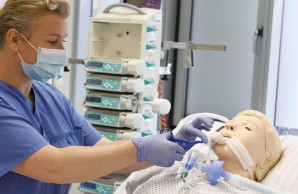 Eine Pflegerin trainiert an einer Puppe die Arbeit mit Patienten der COVID19 Intensivstation